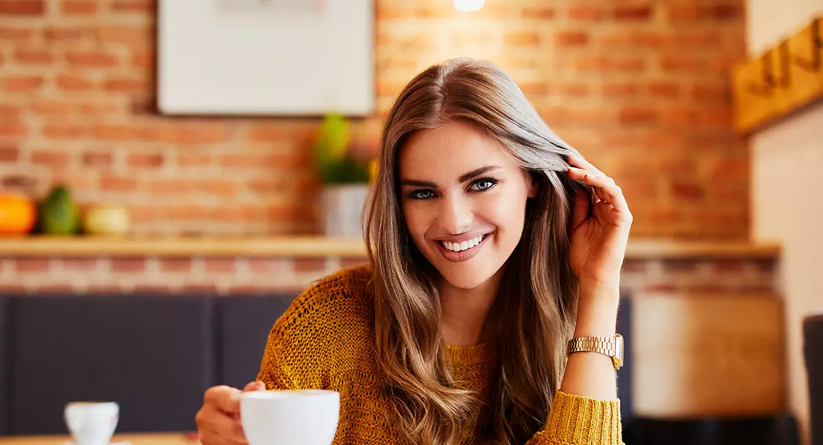 Woman Smiling with Lumineers in a Coffee Shop