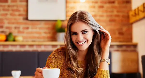 Woman In A Coffee Shop Smiling With Lumineers